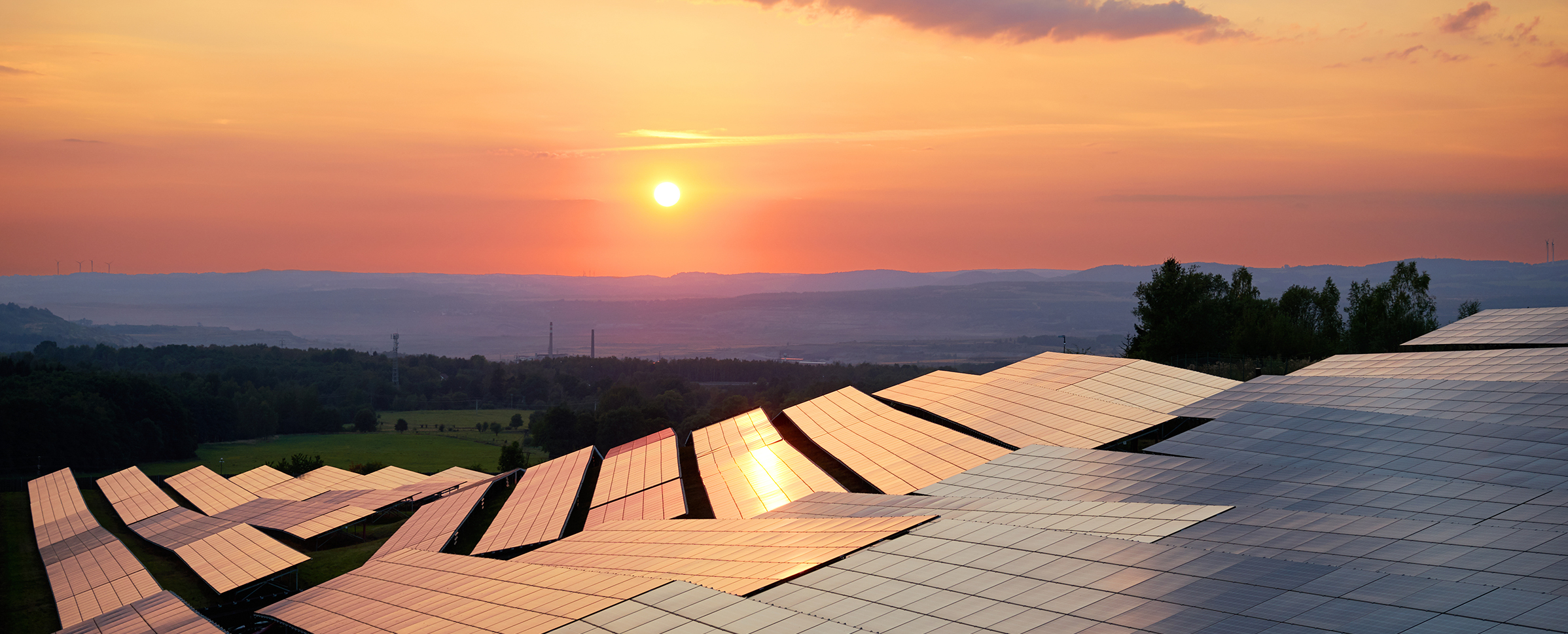 Solar panel farm and sunset landscape.