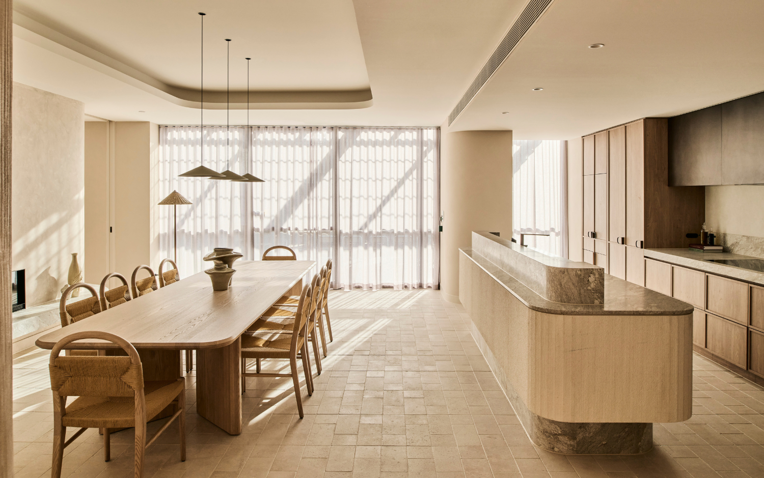 a large living room with a dining table and chairs