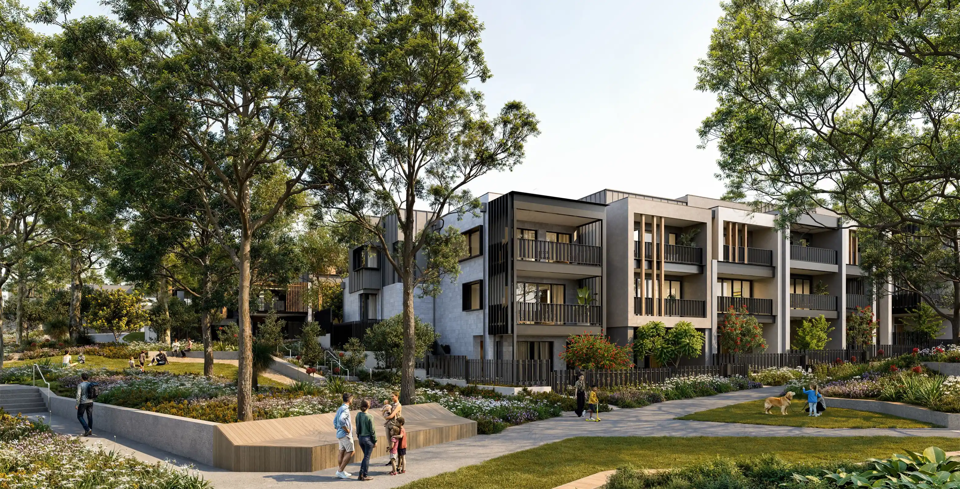 Modern houses with balconies and garages, surrounded by trees and greenery, on a curved road.