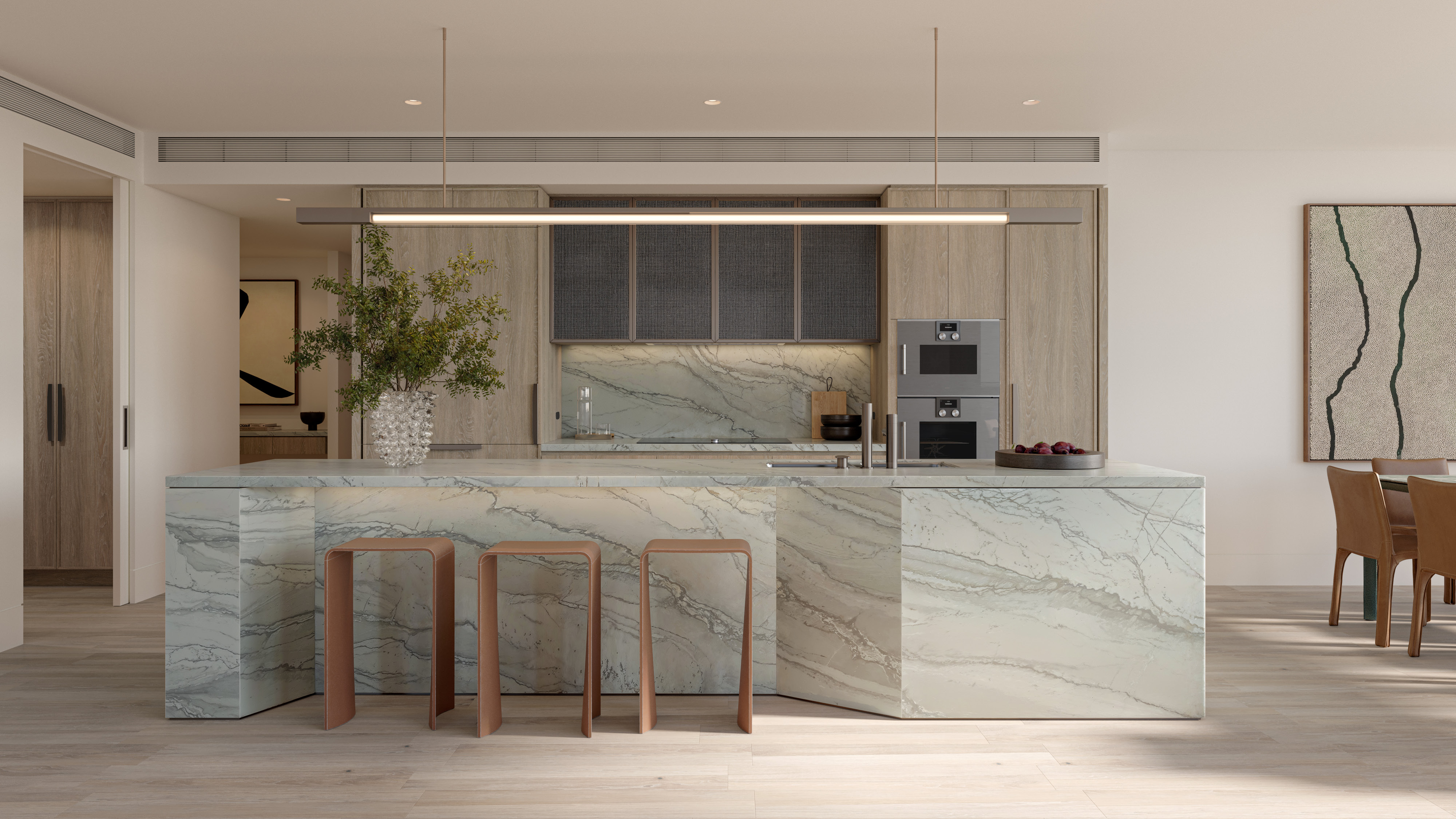 Modern kitchen featuring a marble island, wooden cabinetry, and stylish bar stools. Bright and airy design with elegant decor.