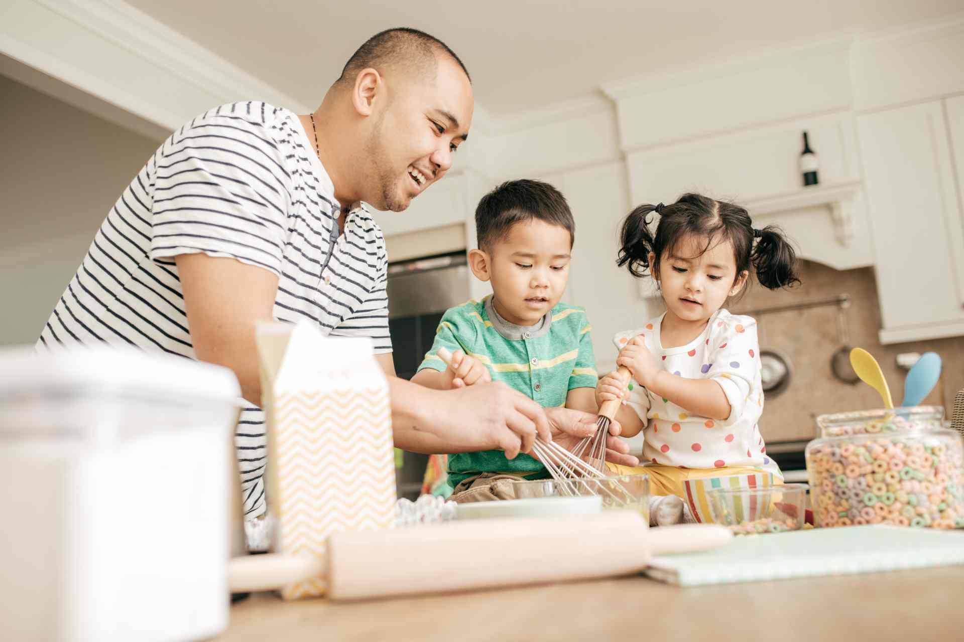 Dad baking with the kids during school holidays