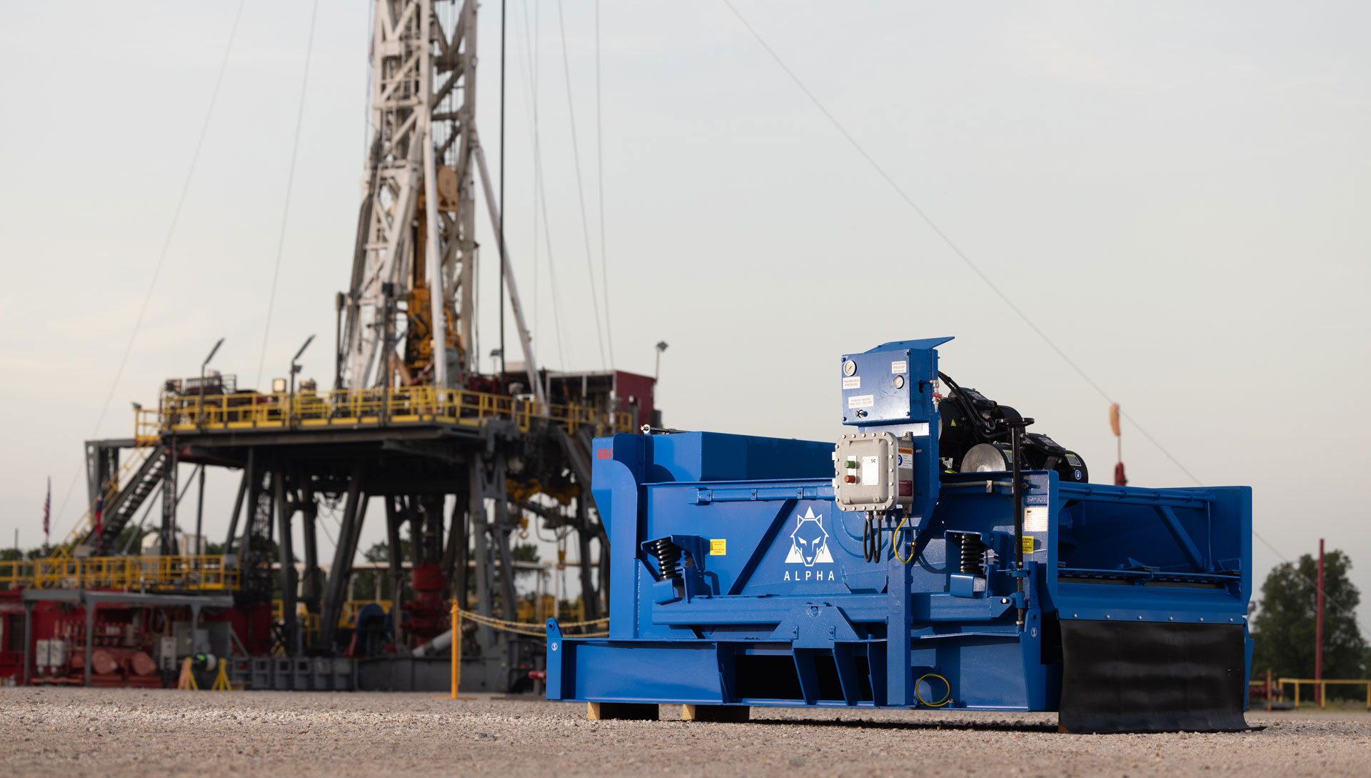 Alpha Shaker at the STC, with a land rig in the background