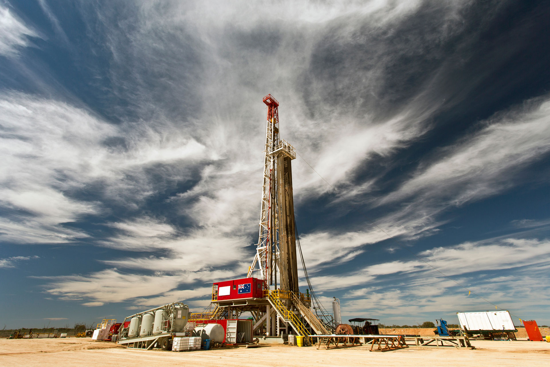 Wide shot of a land drilling rig and cloudy sky