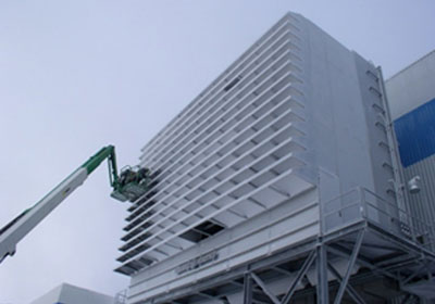 Operators Removing Snow and Ice from Gas Turbine