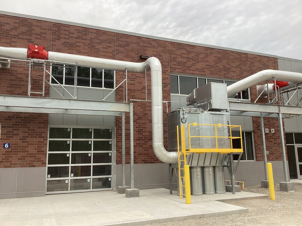 Exterior Nederman dust collector installation with elevated ductwork