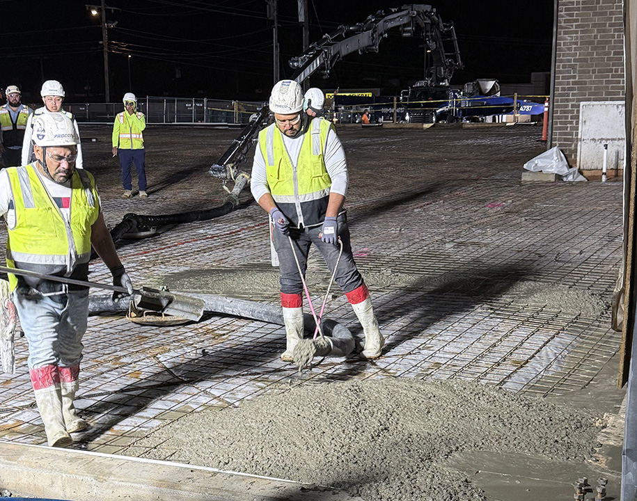 Workers at 3 a.m. preparing to install the concrete floor