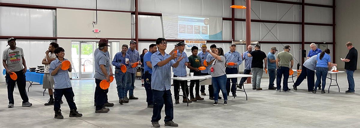 Nordfab employee throwing frisbee