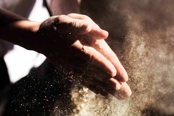 hands rubbing sawdust