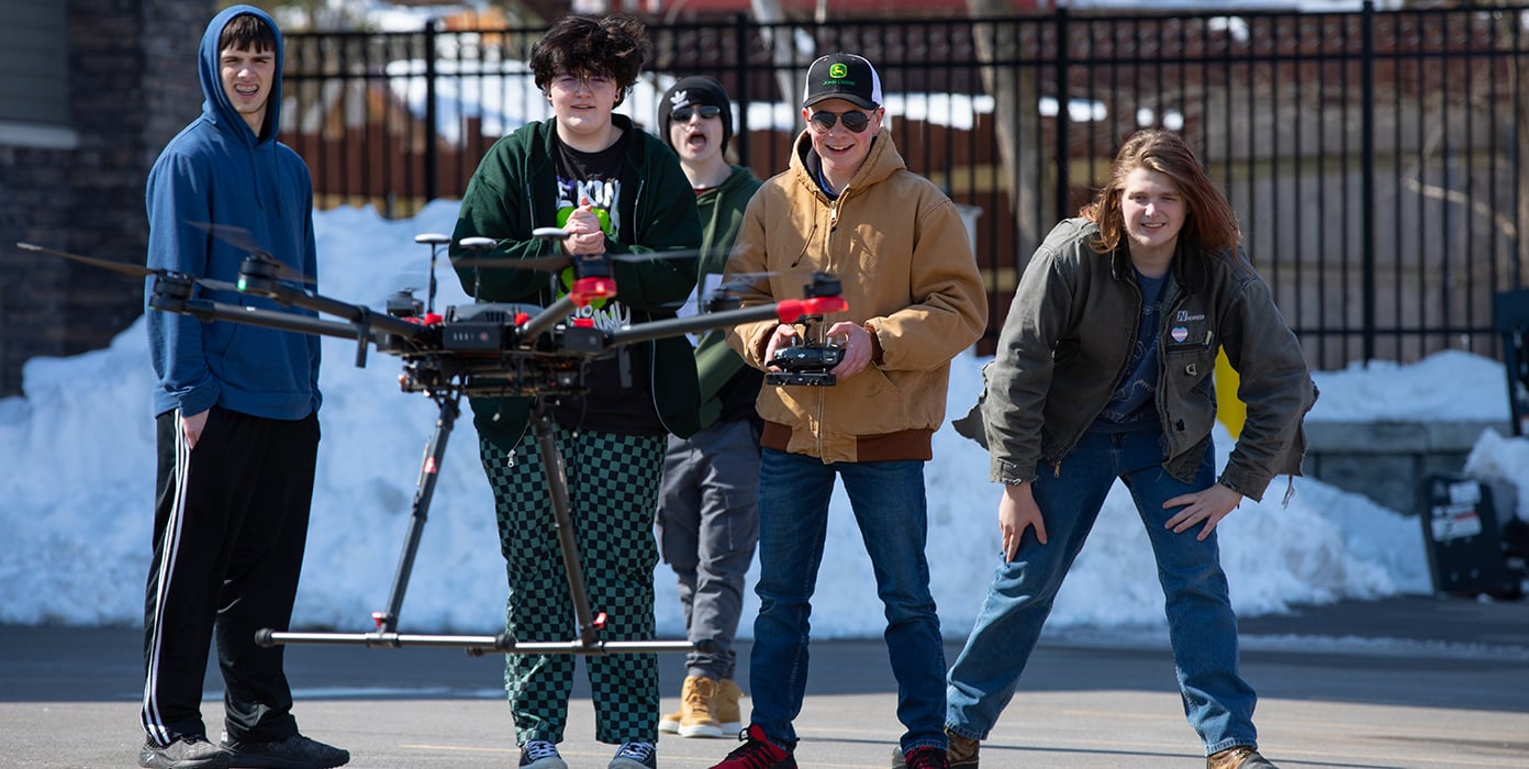 Group of 5 people flying drone 