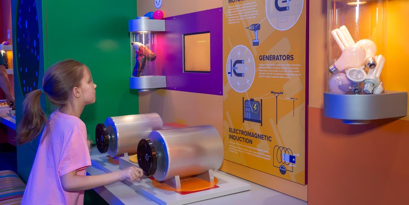 Girl exploring Electromagnetic induction model in Energy zone