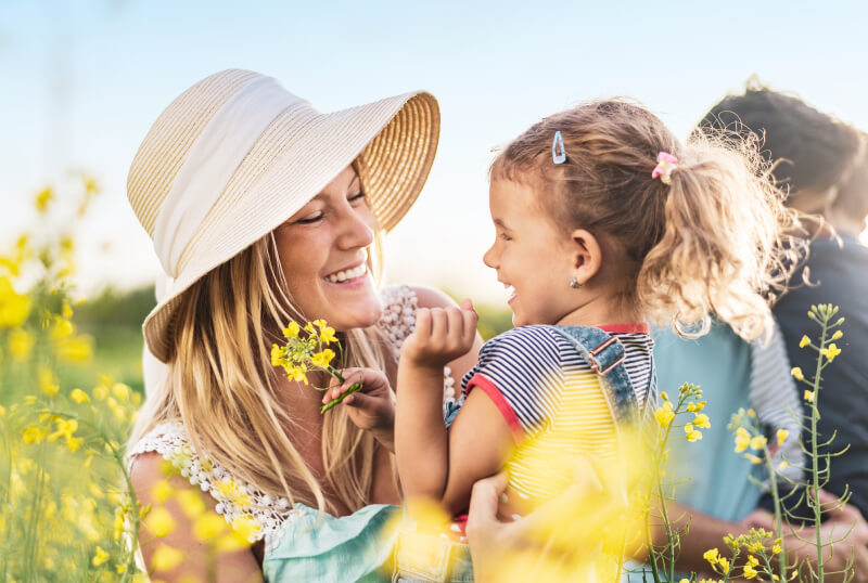 Mother and daughter in field