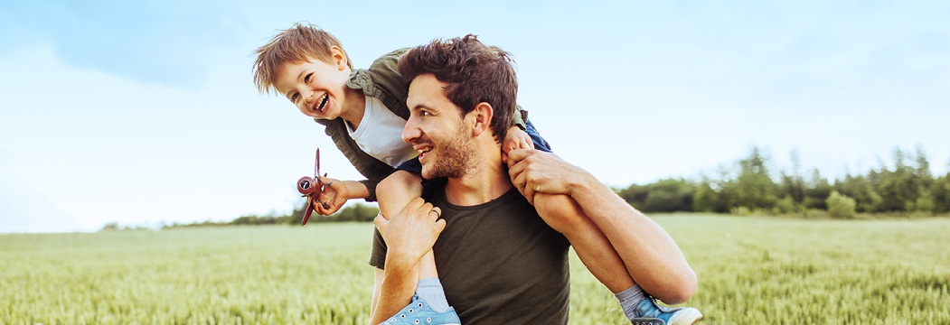 son on Dad's shoulders