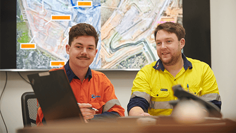 Mining engineers viewing data for mining operations