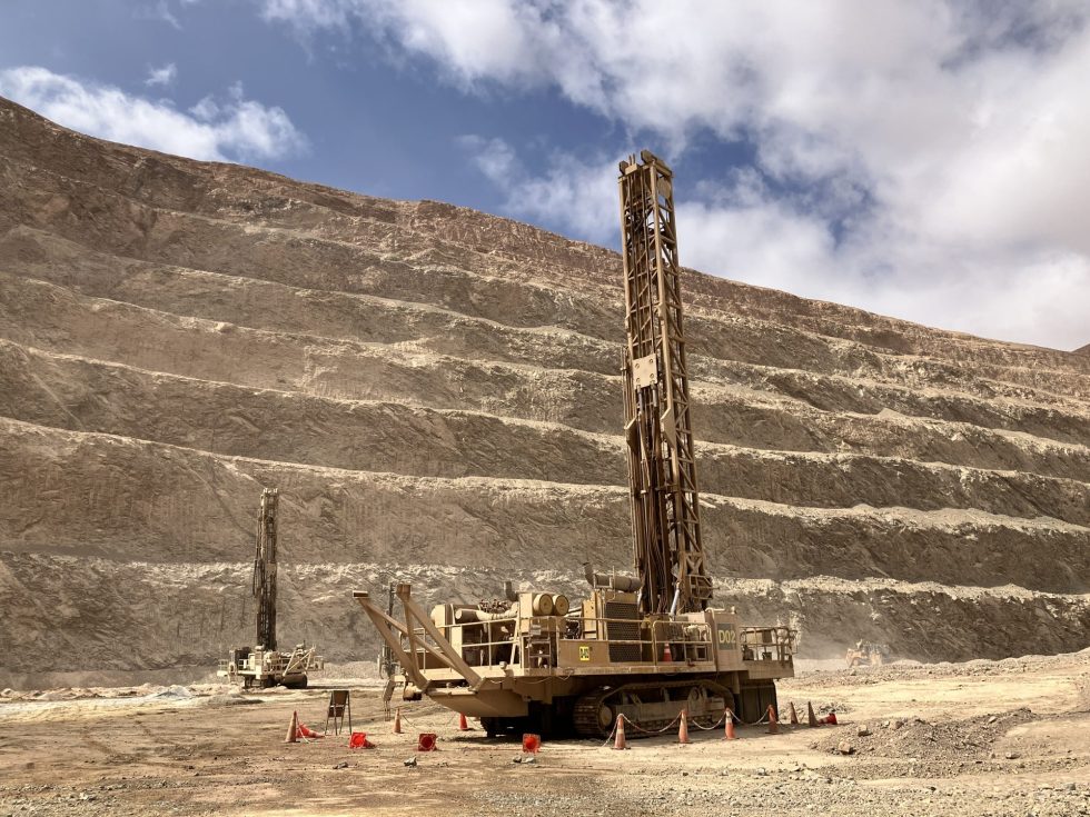 A large drill rig in an open-pit mine
