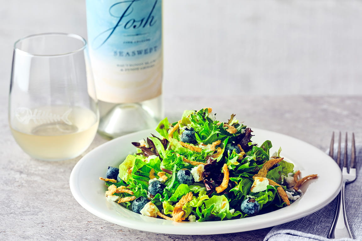 COURSE 1  BLUEBERRY SALAD  Romaine and spring mix with fresh blueberries, goat cheese crumbles, and crispy fried onions, tossed in blueberry balsamic dressing.   JOSH CELLARS SEASWEPT  This wine brings bright citrus and subtle stone fruit notes that beautifully complement the fresh blueberries and tangy goat cheese.