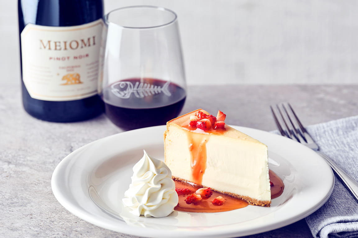 COURSE 4  STRAWBERRY CARAMEL CHEESECAKE  Classic cheesecake topped with warm, chef-crafted strawberry caramel sauce, and finished with diced strawberries and fresh whipped cream.   MEIOMI PINOT NOIR  The ripe red berry notes and soft, silky tannins of the wine perfectly complement the strawberry caramel sauce, while the acidity balances the sweetness of the dessert.