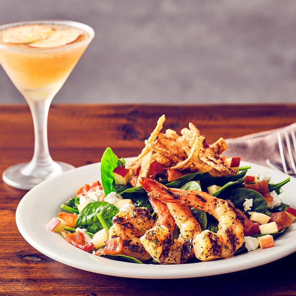 COURSE 2  HARVEST APPLE SHRIMP SALAD Wood-grilled shrimp and fresh spinach, tossed with apple cider vinaigrette, and topped with crispy bacon, diced apples, crumbled goat cheese, and cinnamon wonton strips.  FRESH APPLE BOURBON MARTINI Maker’s Mark bourbon infused with Domaine de Canton liqueur and cinnamon apples, shaken with apple juice, house-made sour mix, and honey syrup—mirroring the salad’s fall flavors while the bourbon’s warmth complements the vinaigrette.