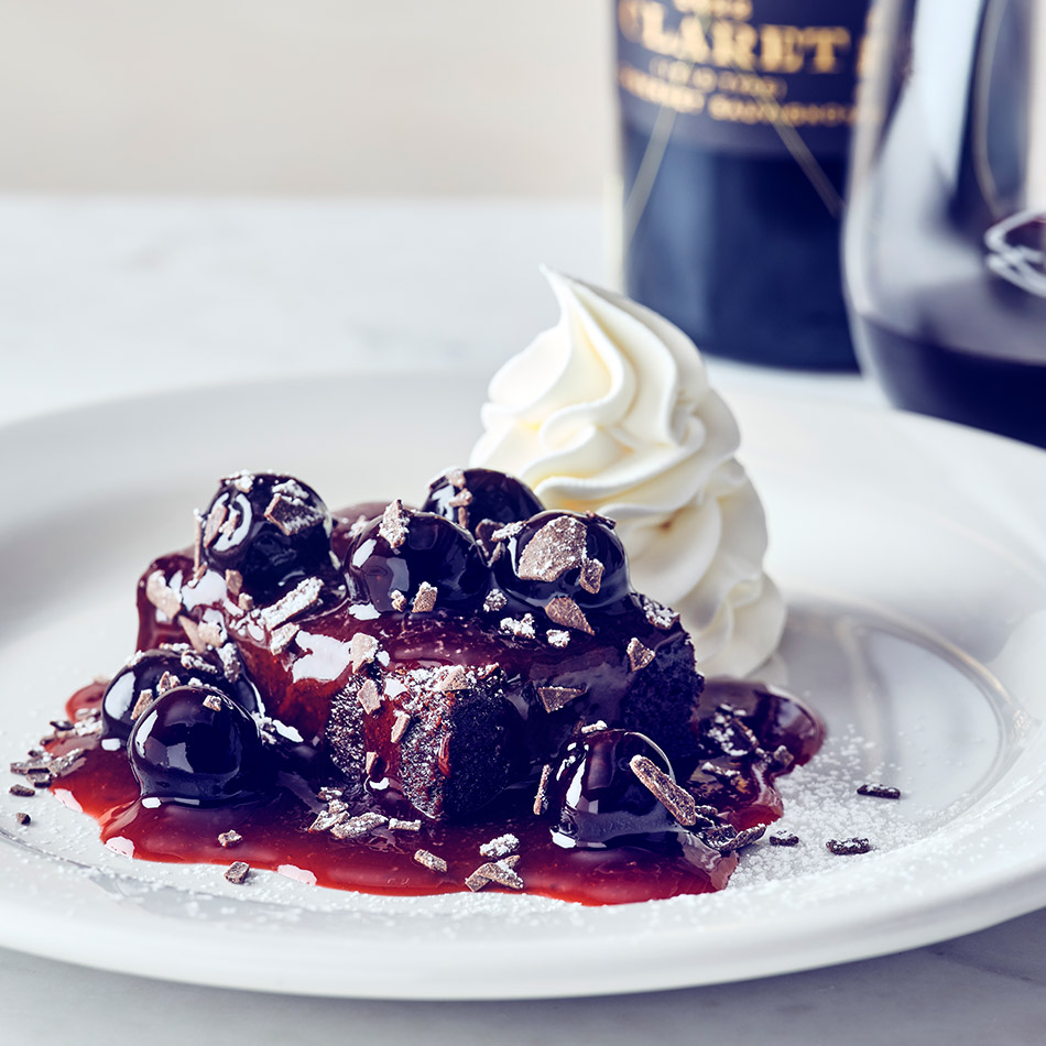 COURSE 4 BLACK FOREST BROWNIE Rich, flourless brownie, smothered in a chef-crafted cherry sauce, topped with powdered sugar and chocolate curls, served with fresh whipped cream. FRANCIS COPPOLA BLACK LABEL CLARET The dark cherry, blackberry, and cocoa notes of the wine echo the flavors in the cherry sauce and chocolate brownie, creating a deep, harmonious match.
