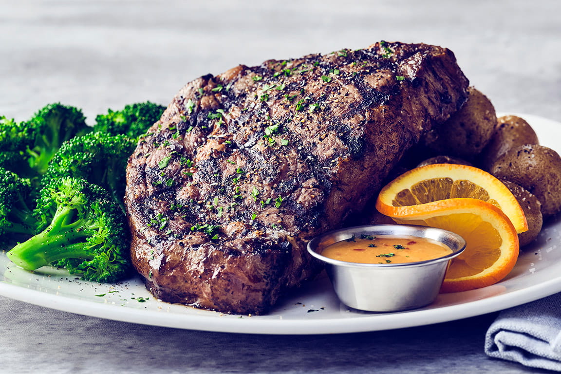 BLUE MOON MISO RIBEYE Wood-grilled, perfectly marbled 16 oz ribeye, paired with chef-crafted Blue Moon miso sauce, served with roasted new potatoes and seasonal vegetable.