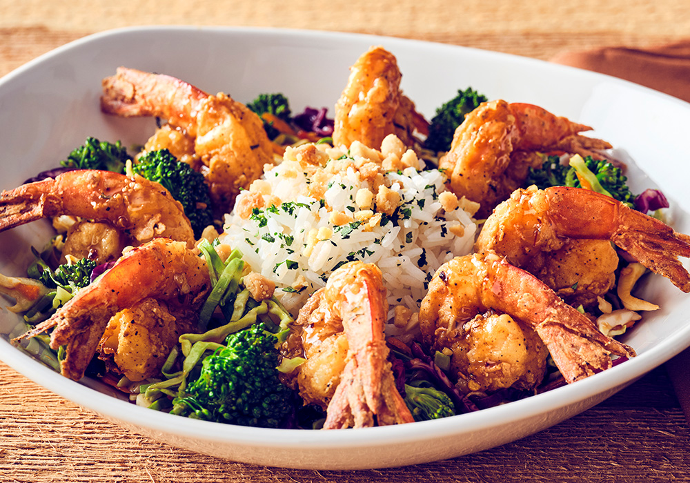 CRISPY BOURBON SHRIMP Crispy Kung Pao marinated shrimp, drizzled with bourbon glaze, served with Kung Pao vegetables, perfect jasmine rice and topped with macadamia nuts.