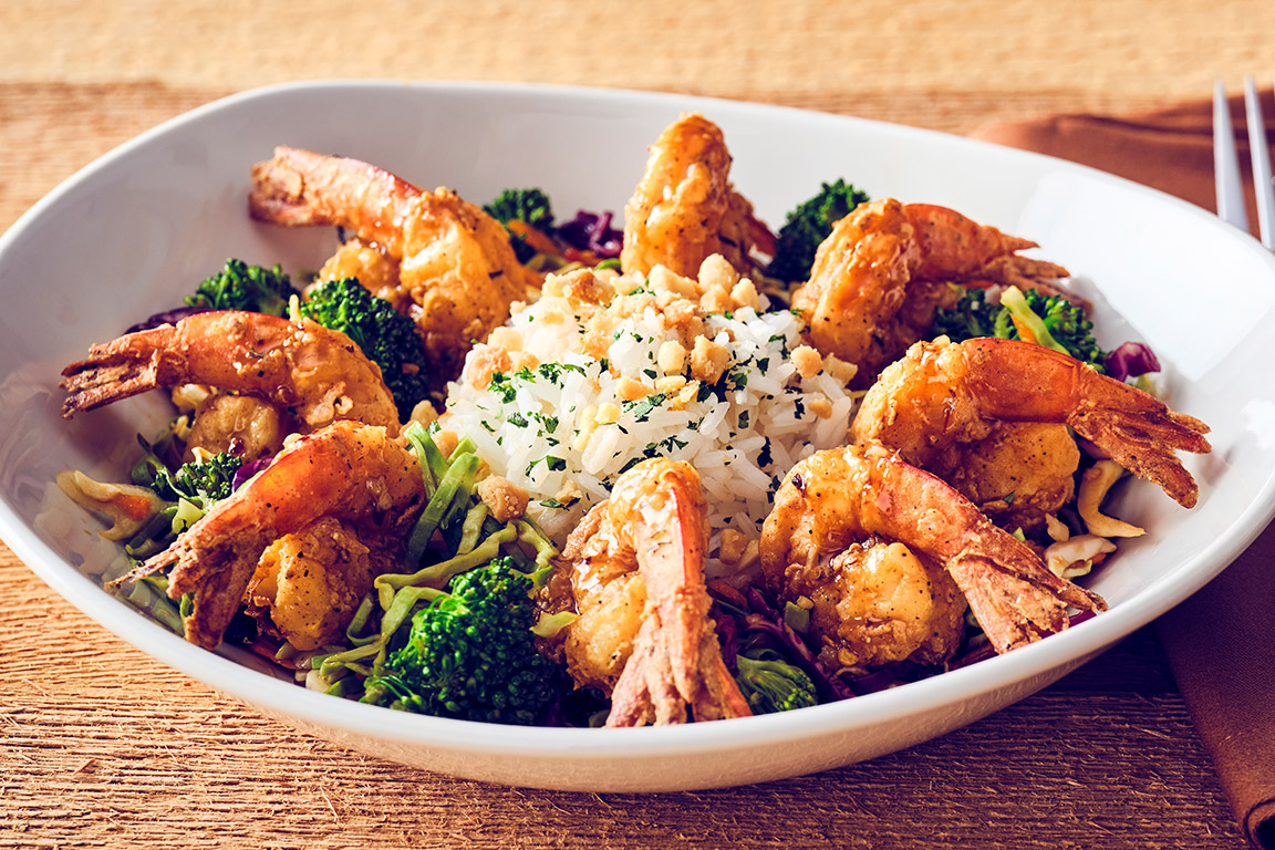 CRISPY BOURBON SHRIMP Crispy Kung Pao marinated shrimp, drizzled with bourbon glaze, served with Kung Pao vegetables, perfect jasmine rice and topped with macadamia nuts.