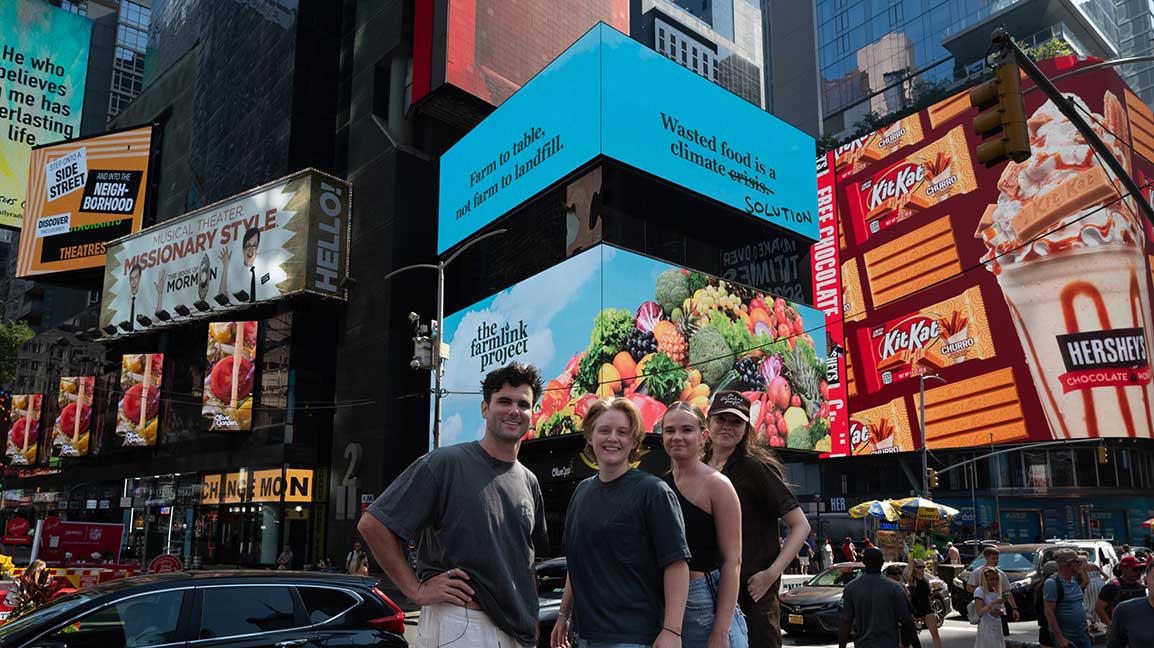 Farmlink Project leadership in front of Times Square Cube digital out of home