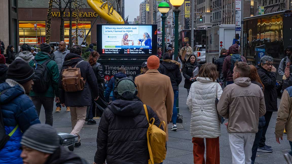 Crowd in front of MJHS digital urban panel in midtown manhattan