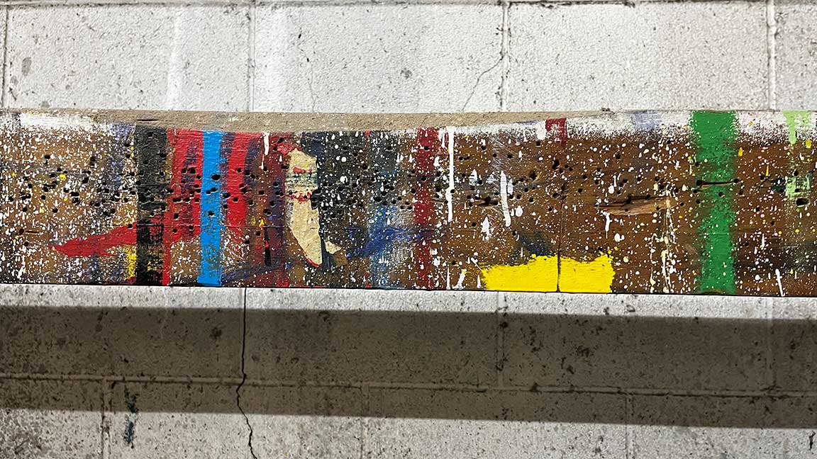 Close-up of paint-splattered slat for billboard construction