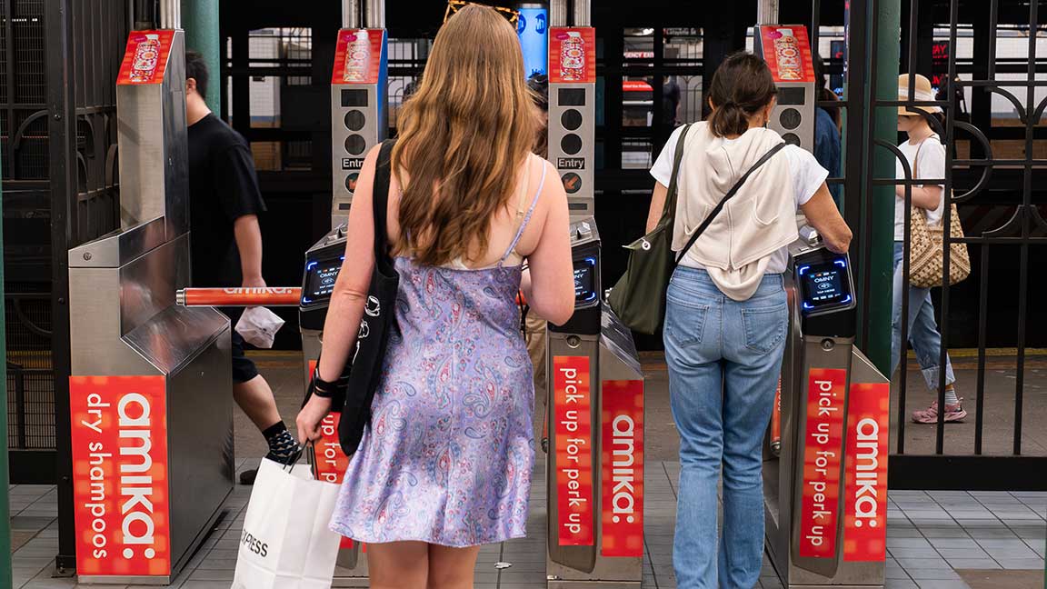 amika subway advertisement on turnstiles, part of Spring Street Station Domination