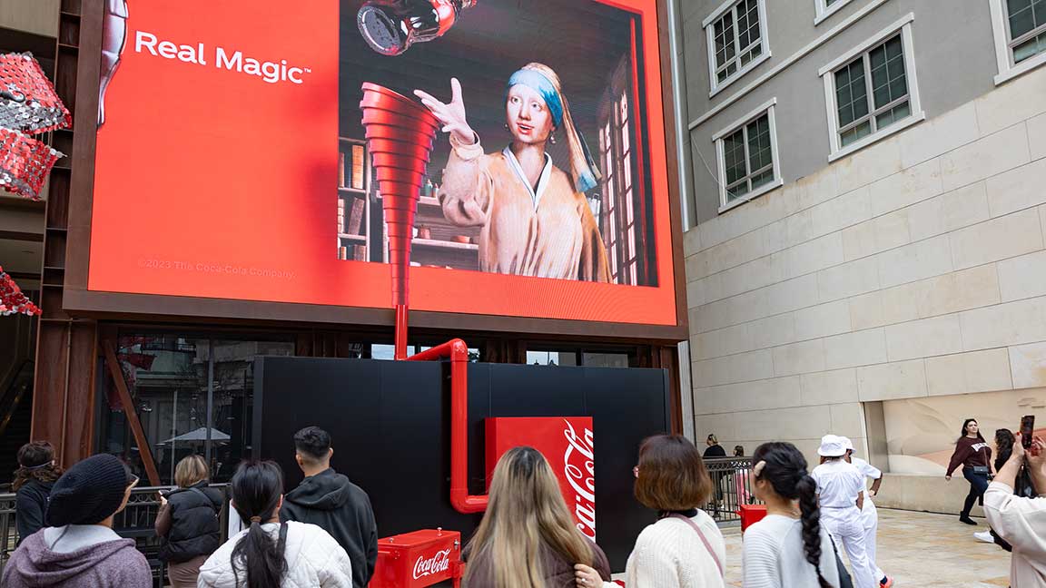 Dispensing a Coca-Cola during a campaign featuring Girl with a Pearl Earring at brand activation at The Americana at Brand