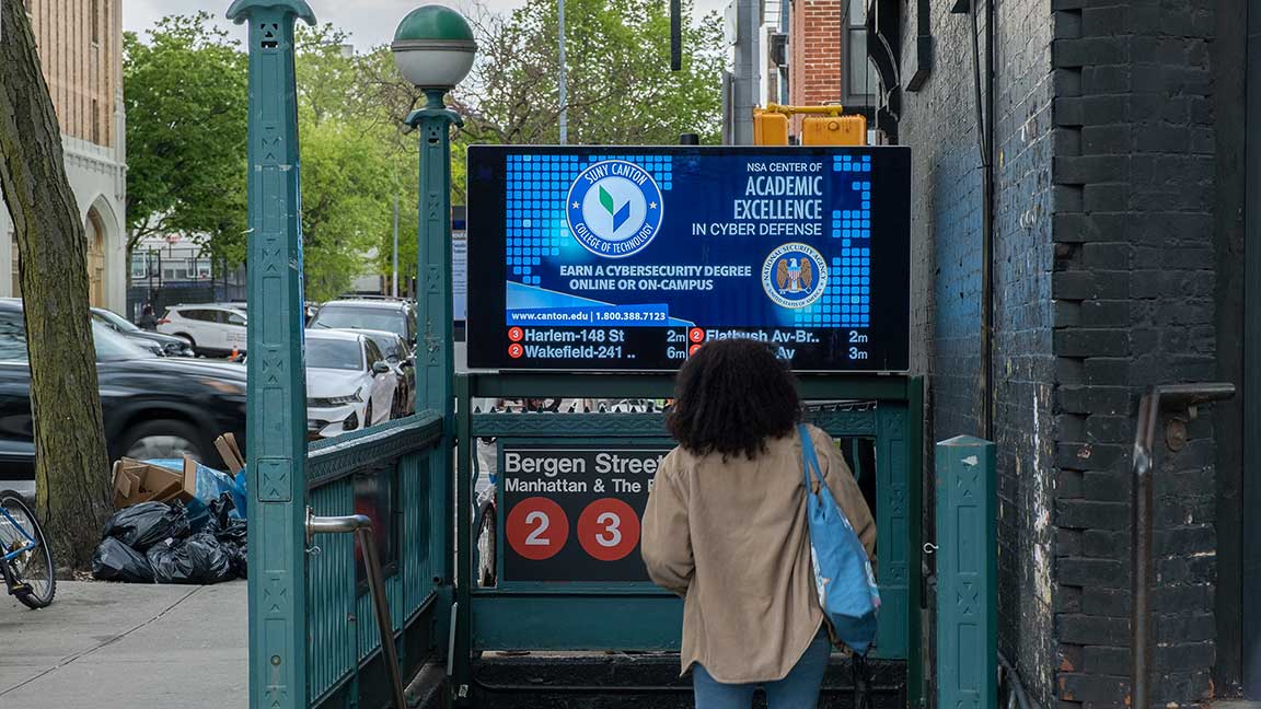 Ad for cyberdefense degree program at SUNY Canton on New York subway Digital Urban Panel