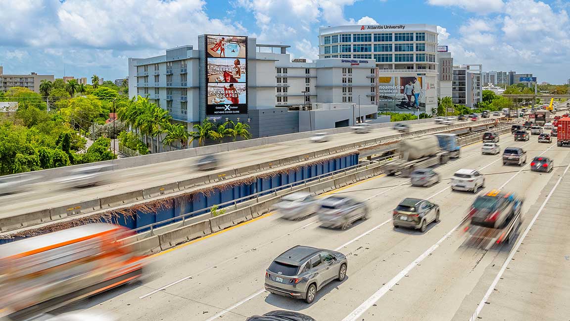 Celebrity Cruises advertisement on a wallscape billboard overlooking Dolphin Expressway in Miami