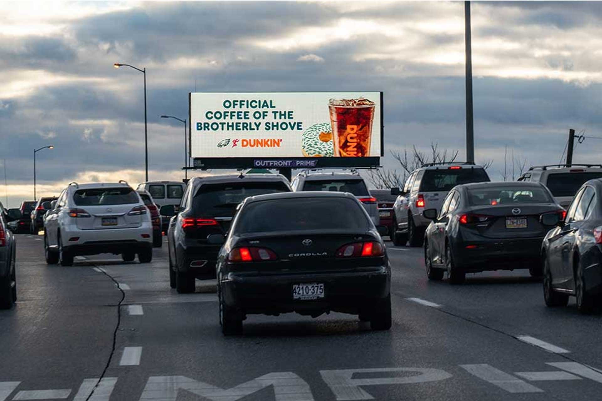 OUTFRONT billboard in Philadelphia for Dunkin featuring contextually relevant Eagles creative