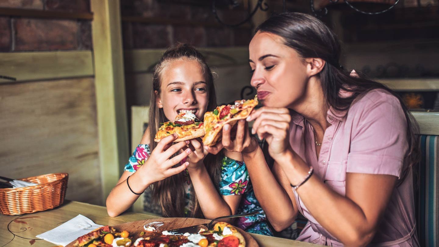 stock image of people eating pizza