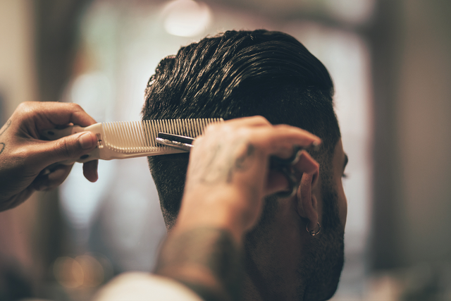 Photo of man getting hair cut