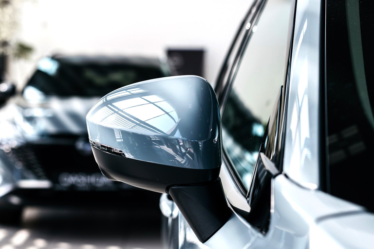 Image depicting a close-up view of a car side mirror, highlighting its sleek design and reflective surface.