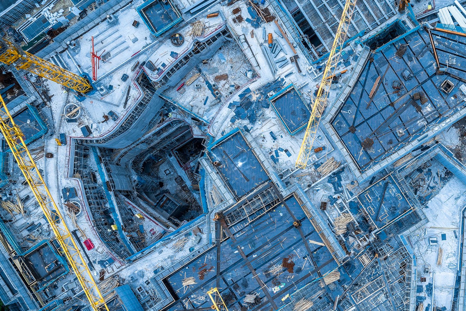 Bird's eye view of an expansive industrial yard, showcasing buildings, machinery, and vehicles in a well-organized layout.