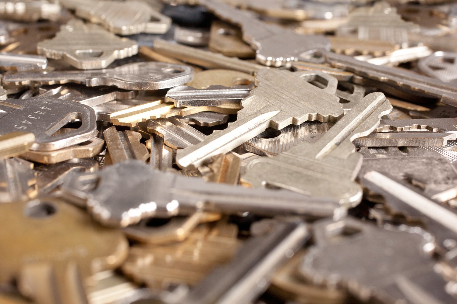 A pile of assorted keys, representing security, access, and protection concepts.