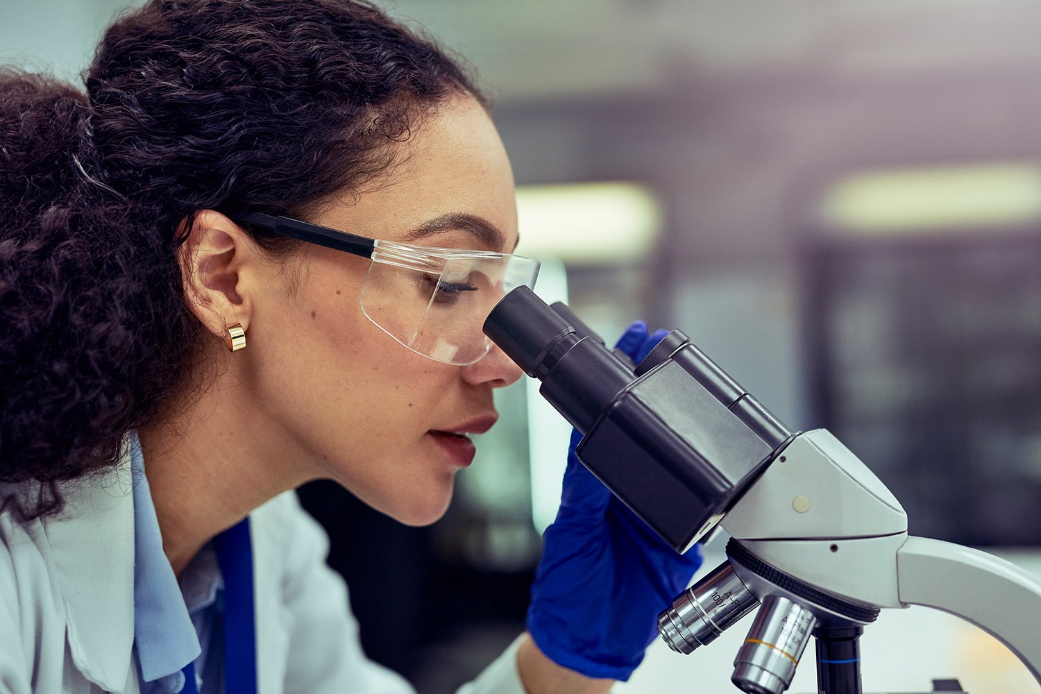 A woman looking in a microscope