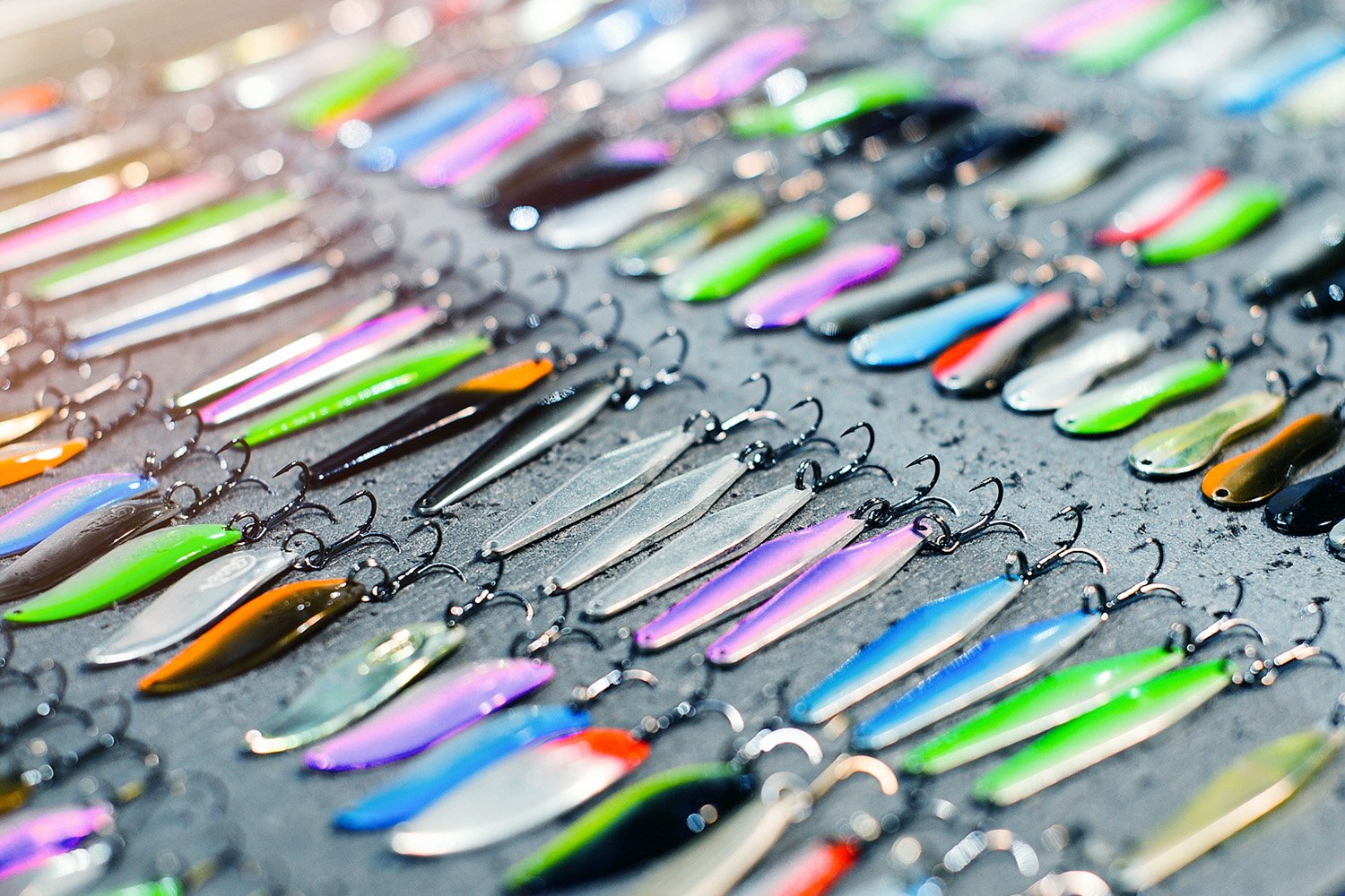 Image of an array of vividly colored fish tackles neatly arranged.