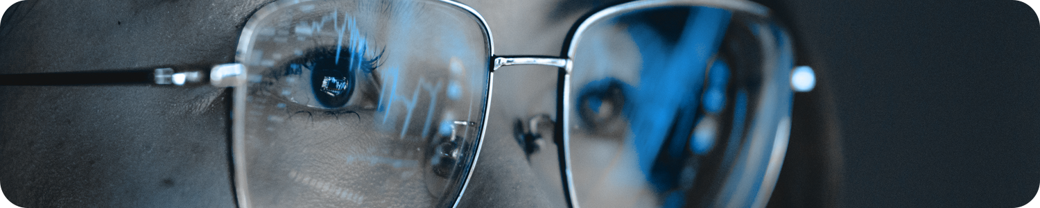 A person's glasses reflecting their screen