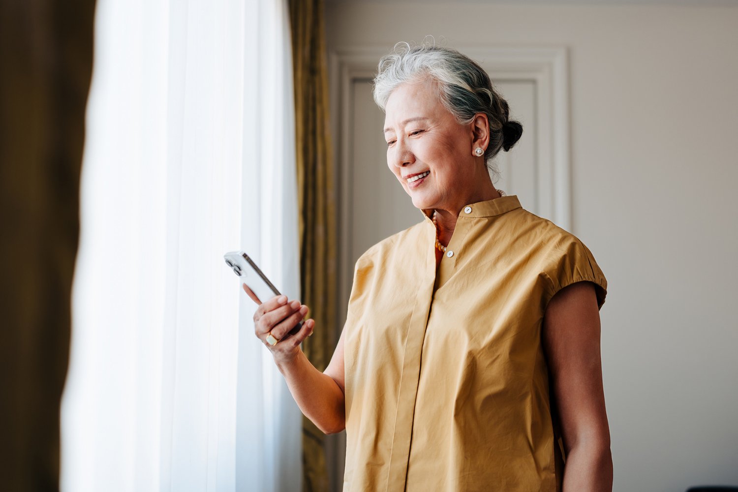 An older woman using her phone to schedule a healthcare appointment