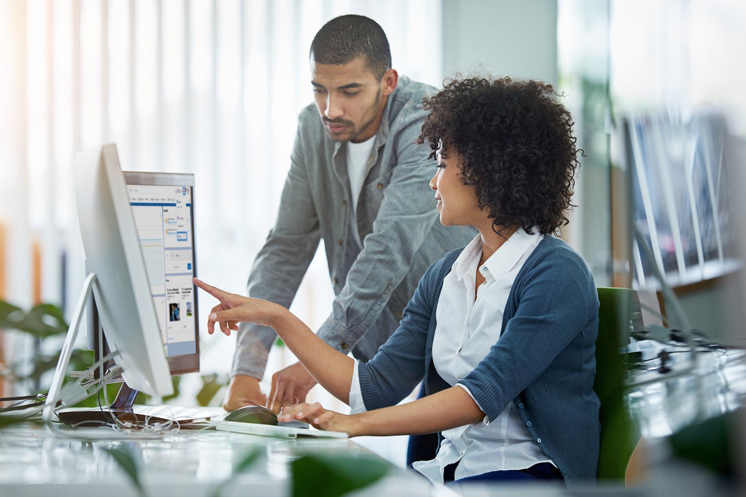 Two people looking at a computer together