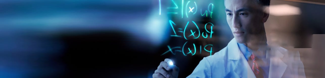 Scientist writing formulas on whiteboard