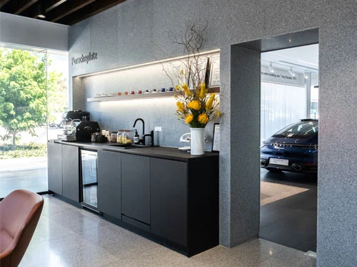 Black and concrete interior kitchen of Porsche Centre