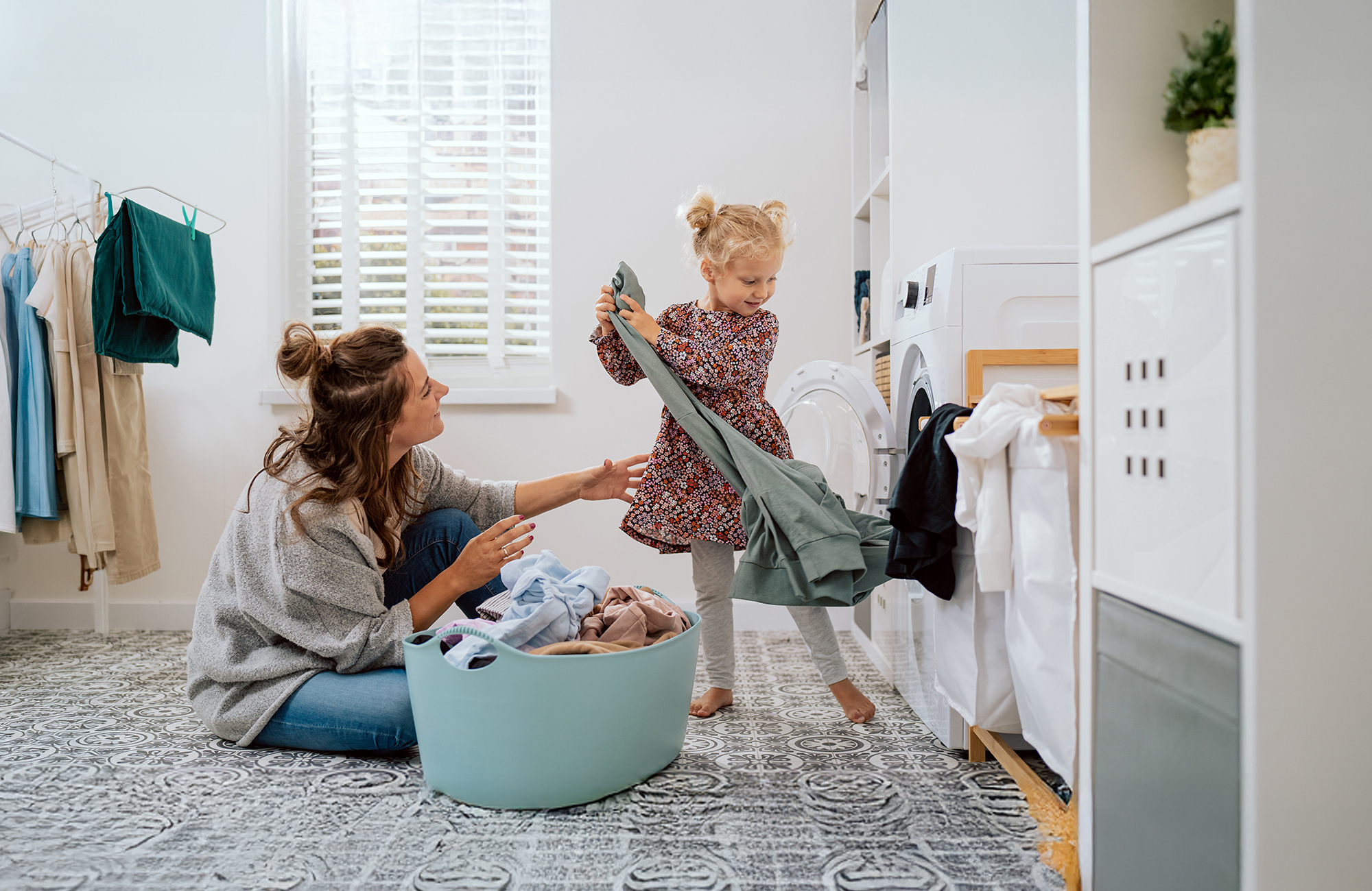 woman and daughter loading laundry