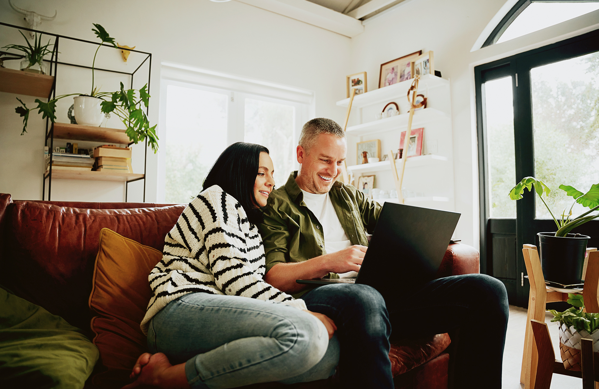 Couple with laptop on a couch