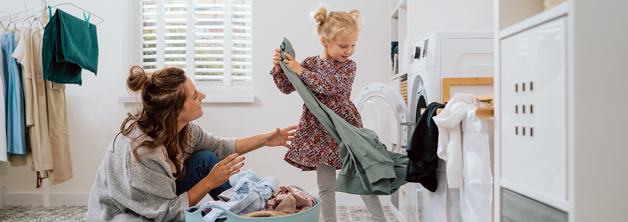 woman and daughter loading laundry