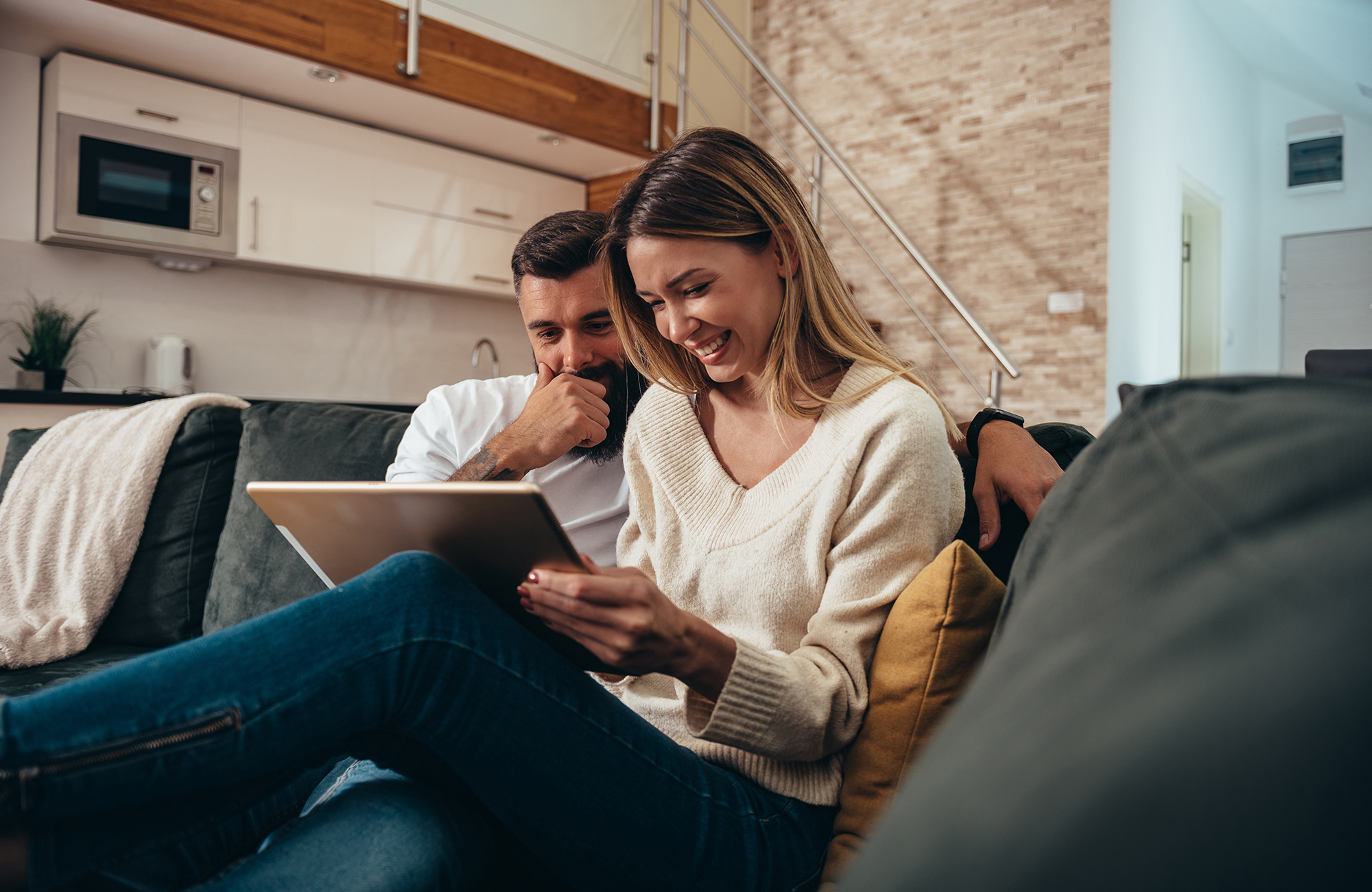 Young couple on a couch with laptop