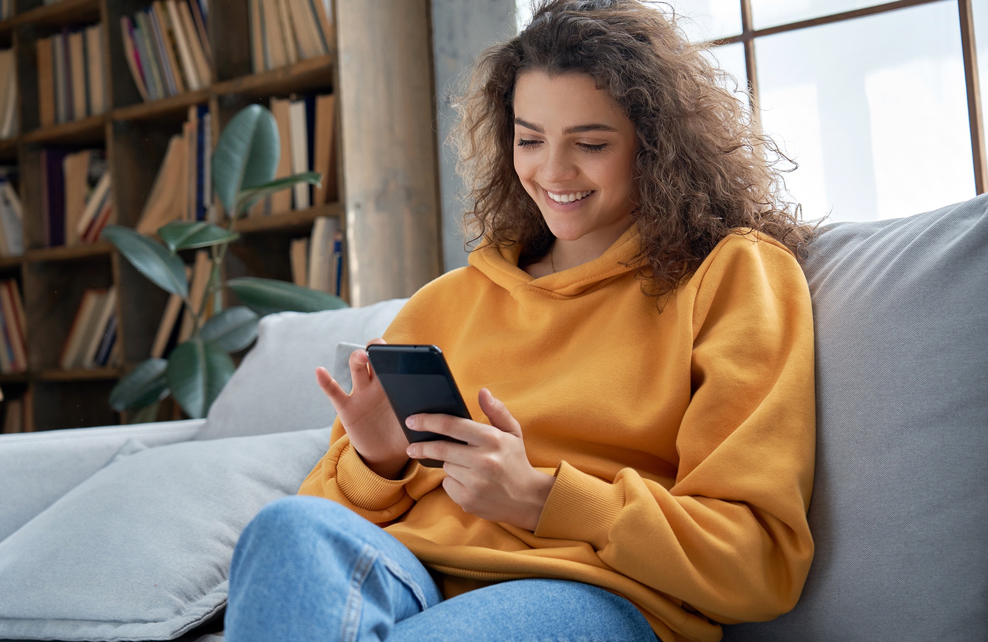 Woman on a couch with smartphone
